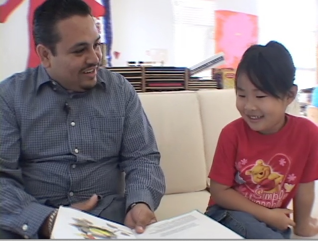 Jenny, a five-year-old language learner listens to her teacher read "Are You My Mother?" in Spanish.